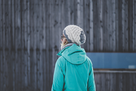 knitted hat woman in front of barn